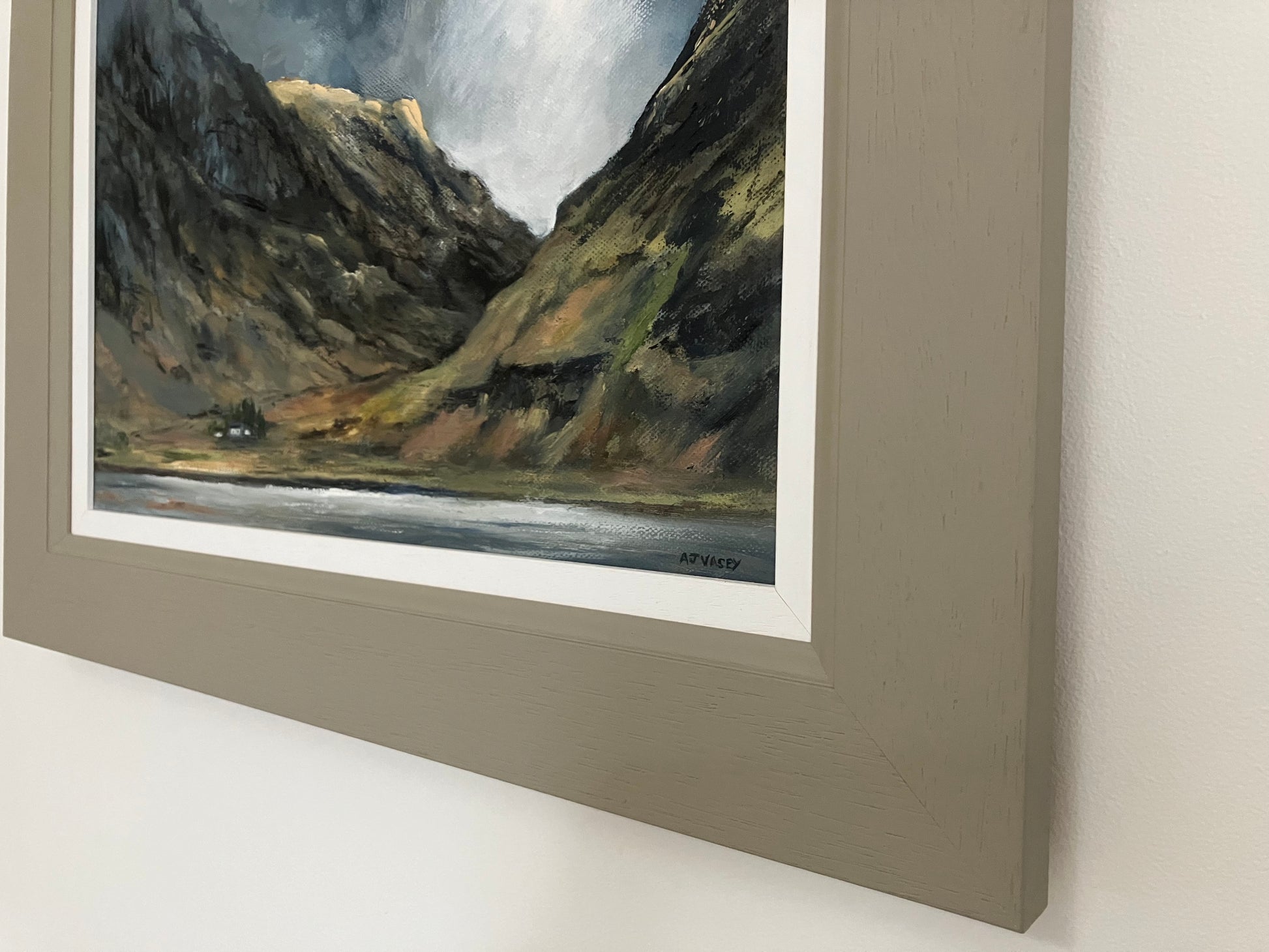 close up of oil painting of mountains in taupe coloured wood frame